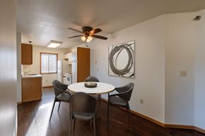 Grand Forks apartment for rent - a dining area with a table and chairs and a ceiling fan. Grand Forks, ND Autumn Ridge Apartments