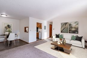 Grand Forks apartment for rent - a living room and dining room with a couch and a table. Grand Forks, ND Cedarwood Apartments