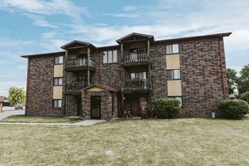 Grand Forks apartment for rent - a brick apartment building with two balconies and a bike parked outside