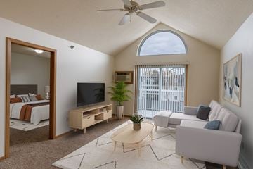 Grand Forks apartment for rent - a living room with a couch and a tv and a bedroom