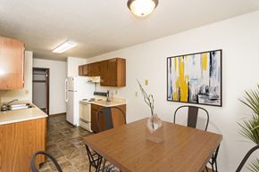 Grand Forks apartment for rent - Grand Forks, ND Grandview I Apartments. a kitchen and dining area with a four chair table and art on the wall