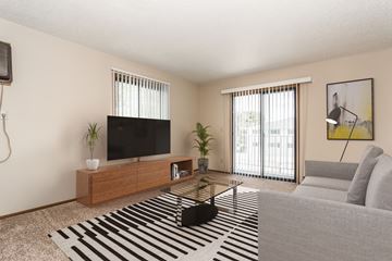 Grand Forks apartment for rent - Grand Forks Harrison and Richfield Apartments. A living room with a couch coffee table and television