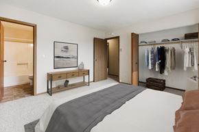 Grand Forks apartment for rent - A bedroom with a large bed and a closet  at Harrison and Richfield, Grand Forks