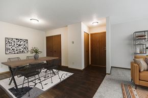 Grand Forks apartment for rent - A dining room with a table and four chairs and the entry door in the background  at Harrison and Richfield, Grand Forks, North Dakota
