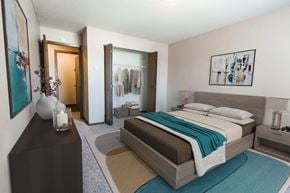 Grand Forks apartment for rent - Grand Forks, ND Library Lane Apartments. a bedroom with a bed, dresser, and a closet