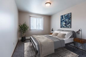 Grand Forks apartment for rent - Grand Forks, ND Mayfair Apartments a bedroom with a large bed and a blue painting on the wall