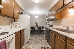 Grand Forks apartment for rent - Grand Forks, ND Mayfair Apartments a kitchen with wooden cabinets and white appliances