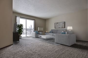 Grand Forks apartment for rent - Grand Forks Kremer Apartments  a living room with a couch and a chair with a glass sliding door