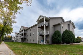 Grand Forks apartment for rent - Grand Forks, ND Primrose Court Apartments. Exterior of a three level building with balconies and patios
