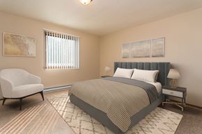 Grand Forks apartment for rent - Grand Forks, ND Ridgemont Apartments. a bedroom with a bed and a chair
