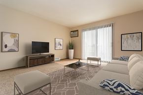 Grand Forks apartment for rent - Grand Forks, ND Ridgemont Apartments. a living room with beige walls and a large glass slidng door