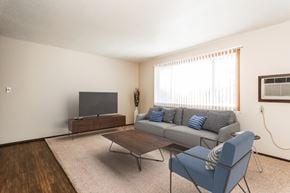 Crookston apartment for rent - Grand Forks, ND Riverwood Apartments. A living room with a couch and a chair and a television