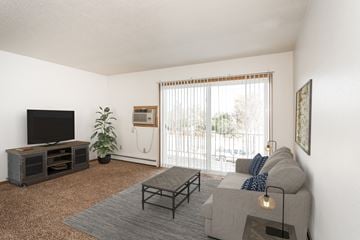Crookston apartment for rent - a living room with a couch and a tv and a balcony