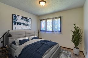 Grand Forks apartment for rent - Grand Forks, ND Roughrider Apartments.  a bedroom with a large bed and two windows