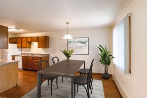 Grand Forks apartment for rent - A dining room and kitchen with a table and chairs. Grand Forks, ND Southview Apartments.