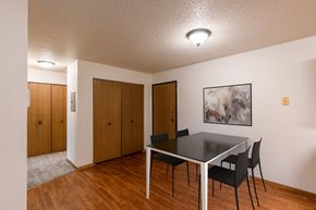 Grand Forks apartment for rent - A dining room with a table and chairs and a painting on the wall. Grand Forks, ND Southview Apartments.