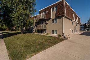 Grand Forks apartment for rent - Grand Forks, ND Stanford Apartments. an apartment building with balconies and a large lawn