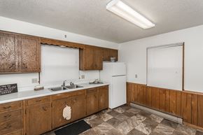 Grand Forks triplex for rent - Grand Forks, ND Valley Home Duplex. a kitchen with white appliances and wooden cabinets