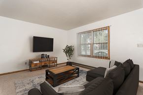 Grand Forks triplex for rent - Grand Forks, ND Valley Home Duplex.  a living room with a couch and coffee table and a tv on the wall