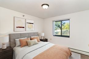 Hutchinson apartment for rent - a bedroom with a bed and nightstands. Hutchinson, MN Deer Park Apartments
