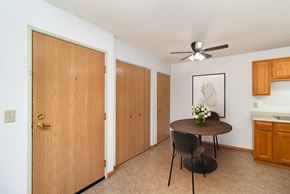 Hutchinson apartment for rent - a dining room with a table and a ceiling fan. Hutchinson, MN Deer Park Apartments