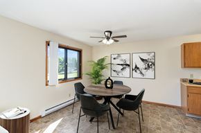Hutchinson apartment for rent - a dining room with a table and chairs and a ceiling fan. Hutchinson, MN Echo Manor Apartments