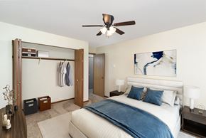 Hutchinson townhouse for rent - a bedroom with a large bed and a ceiling fan. Hutchinson, MN Twin Oaks