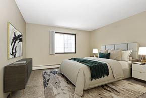 Fridley apartment for rent - Georgetown on the River Apartments, Fridley, MN, 55432. A bedroom with a bed and a dresser.