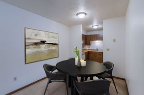 Moorhead apartment for rent - a dining room with a table and chairs and a kitchen. Moorhead, MN South Park Apartments
