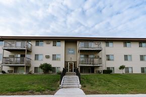 Moorhead apartment for rent - an apartment building with stairs and a green lawn. Moorhead, MN South Park Apartments
