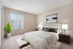 Omaha apartment for rent - Omaha, NE Evergreen Terrace Apartments. Bedroom with a large white bed and a large window