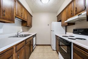 Omaha apartment for rent - Omaha, NE Maple Ridge Apartment. A kitchen with white countertops and wooden cabinets