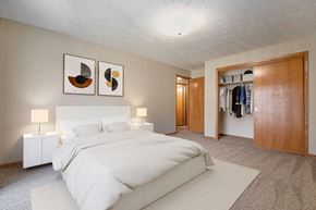Omaha apartment for rent - Omaha, NE Woodland Pines Apartments. A bedroom with a bed and a wardrobe