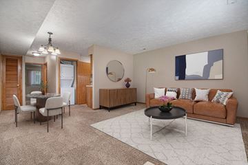 Omaha apartment for rent - a living room and dining room with a couch and a table