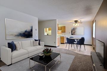 Fargo apartment for rent - a living room with a couch and a coffee table in front of a dining room