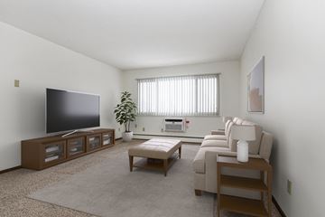 West St. Paul apartment for rent - a living room in west st paul at Covington apartments  with a couch and a coffee table in front of a flat screen tv