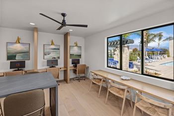 A living room with a table and chairs and a large window