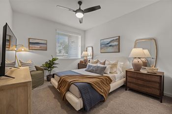 A bedroom with a bed and a ceiling fan