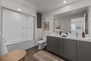 A bathroom with a shower toilet and sink and a mirror