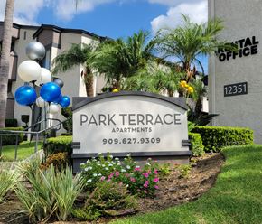 Chino apartment for rent - a sign for park terrace apartments in front of plants and flowers