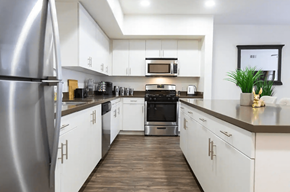 Ontario apartment for rent - a kitchen with white cabinets and stainless steel appliances