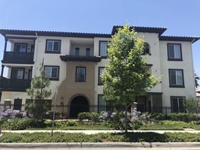 Ontario apartment for rent - the front of an apartment building with trees and flowers