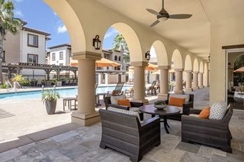 California room with built-in fireplace opening to pool area