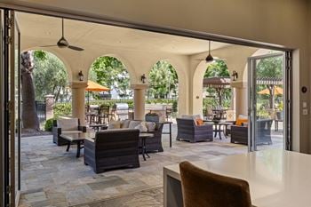California room with built-in fireplace opening to pool area