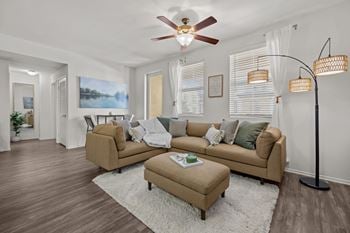 Spacious living room with sectional sofa and ceiling fan
