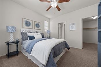 Bedroom with walk-in closet and ceiling fan