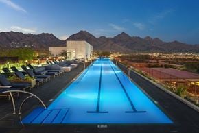 Scottsdale apartment for rent - A long blue pool with a mountain in the background.