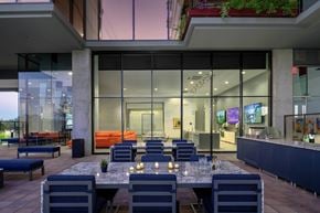 Scottsdale apartment for rent - A modern outdoor dining area with a long table set for a meal.