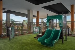 Scottsdale apartment for rent - A playground with a green slide and a sign that says "KIDS".