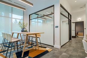 Atlanta apartment for rent - A modern dining room with a wooden table and chairs.